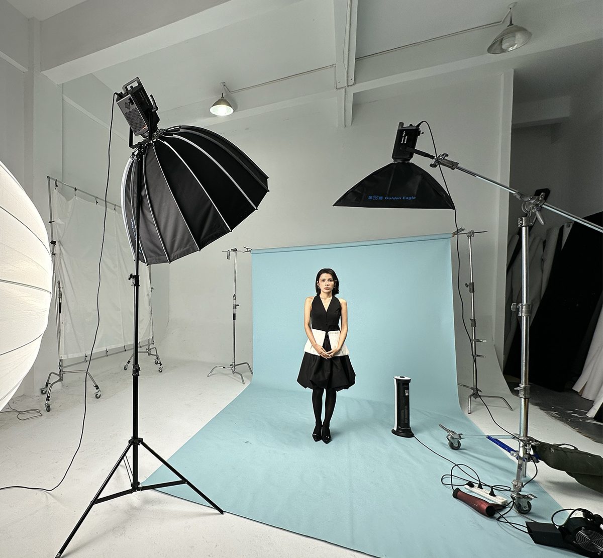 M series fixtures rigged with parabolic and strip softboxes in a photo studio
